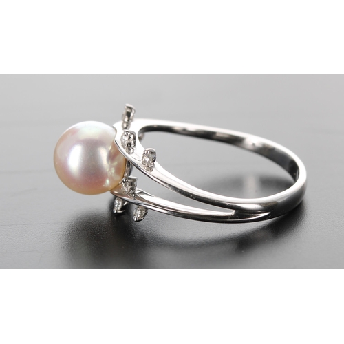 133 - Modern 18ct white gold cultured pearl and diamond dress ring, the pearl 8mm, with eight small round ... 