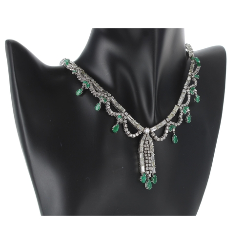 176 - A fine white gold emerald and diamond set fringe drop necklace, set with marquise and pear shaped em... 