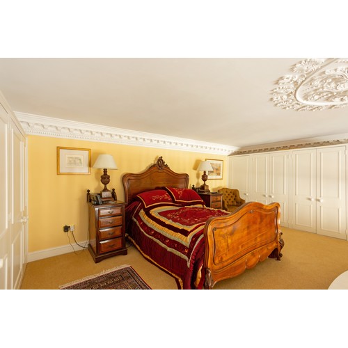 771 - Impressive French walnut carved double bed frame, the headboard with carved leaf scroll finial, rais... 