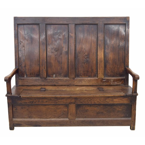 763 - Georgian oak and elm box settle, the four panel back over a hinged seat enclosing an open box beneat... 