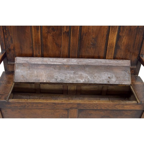 763 - Georgian oak and elm box settle, the four panel back over a hinged seat enclosing an open box beneat... 