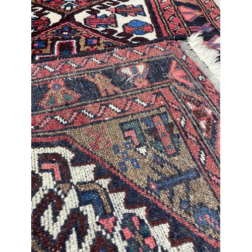 751 - Small Afghan Heriz type rug, on a red ground, 53