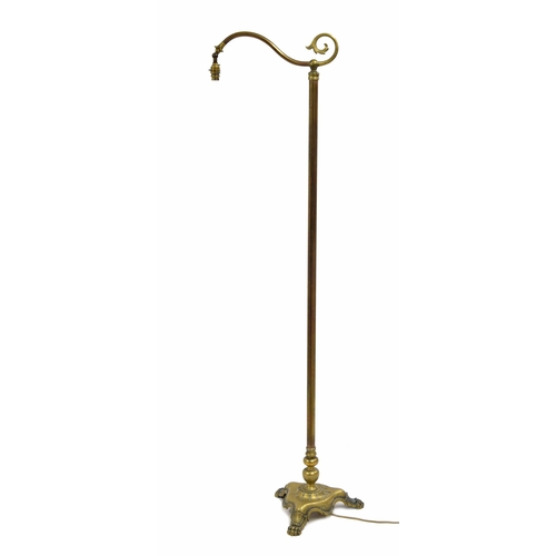 786 - Art & Crafts style brass standard reading lamp, on a trefoil base with cast paw feet, 65