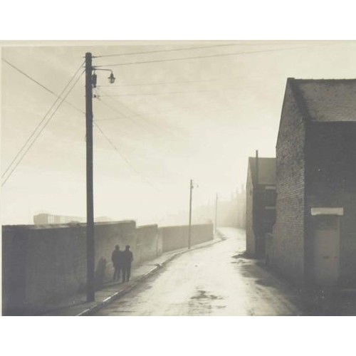 726 - E.Chambré Hardman (20th/21st century) - street scene in the north of England with two figures walkin... 