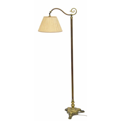 786 - Art & Crafts style brass standard reading lamp, on a trefoil base with cast paw feet, 65