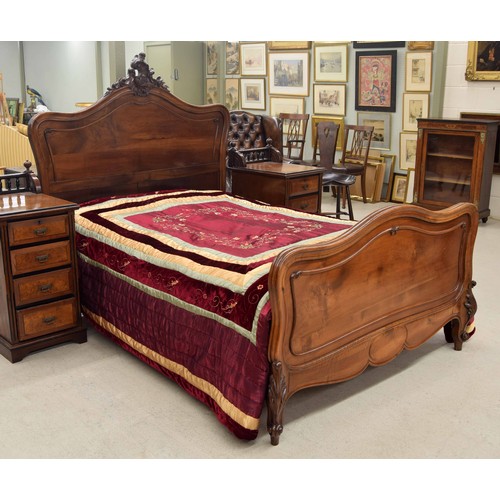 771 - Impressive French walnut carved double bed frame, the headboard with carved leaf scroll finial, rais... 