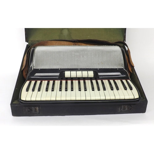 1502 - Gaudini piano accordion with one hundred and twenty buttons and five switches, black finish, case... 