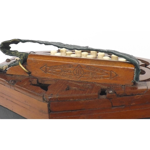 1516 - C. Jones concertina in need of restoration, with twenty-seven bone buttons on pierced mahogany ends,... 