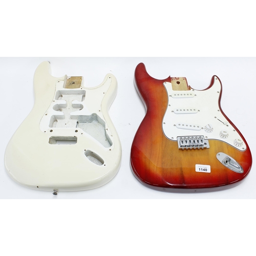 1140 - Two Strat type guitar bodies for projects, one fitted with pickguard, electrics and bridge (2)... 