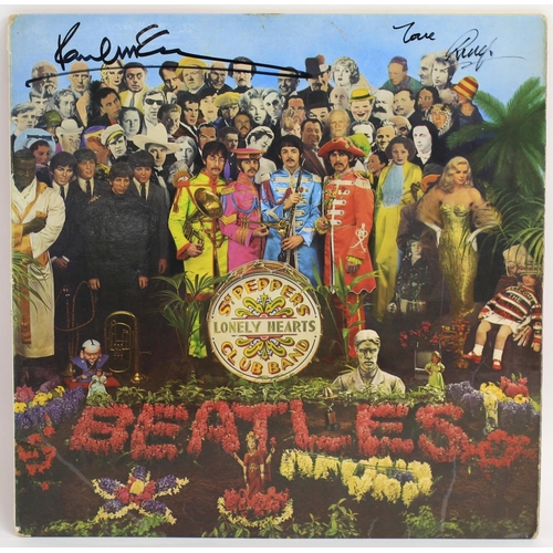 690 - The Beatles - an autographed 'Sgt Pepper's' vinyl record, signed in black pen 'Paul McCartney' and '... 