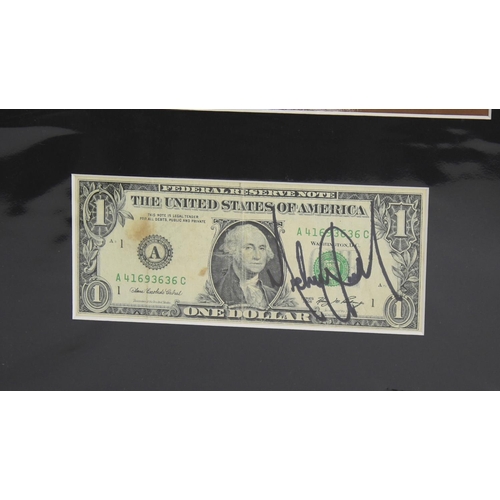 692 - Michael Jackson - autographed dollar bill, mounted below a picture of the artist, 16.5