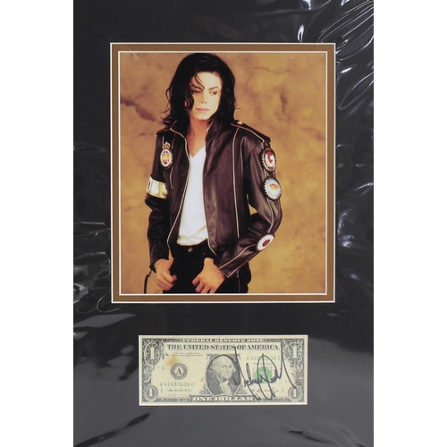 692 - Michael Jackson - autographed dollar bill, mounted below a picture of the artist, 16.5