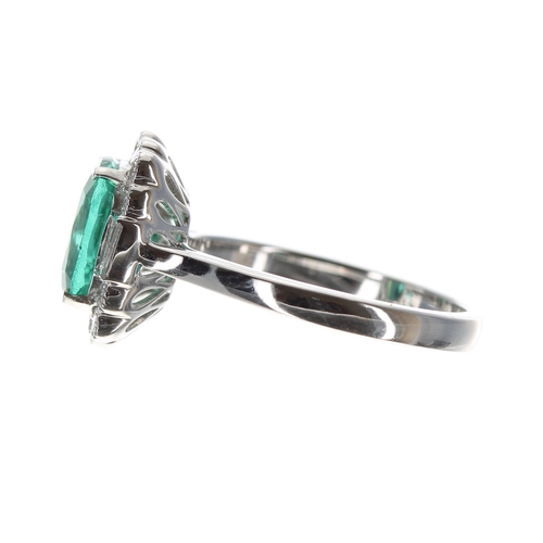 26 - Impressive 18ct white gold emerald and diamond cluster ring in the Art Deco style, the cushion-cut e... 