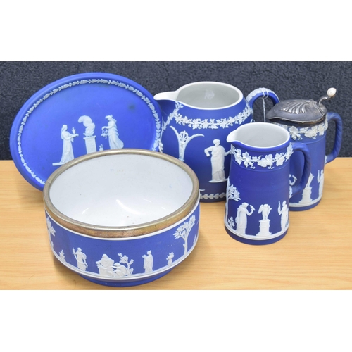 11 - Five pieces of Wedgwood blue Jasperware, including a silver plate mounted fruit bowl, bulbous jug, o... 