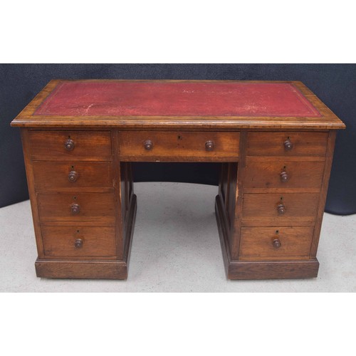 373 - Victorian oak pedestal desk, the top with a red leather inset, over nine drawers to the kneehole fri... 