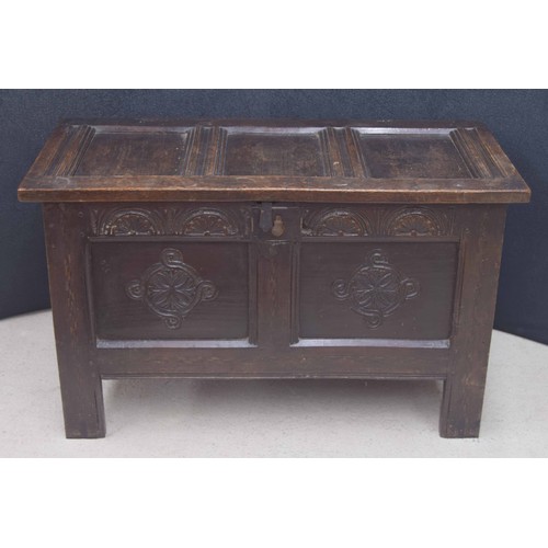 374 - 17th/18th century oak coffer, the three panelled hinged cover enclosing an open interior with candle... 