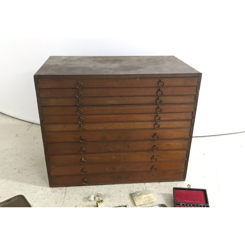 373 - Eleven drawer wooden watchmakers chest, one drawer containing a quantity of watch mainsprings; toget... 