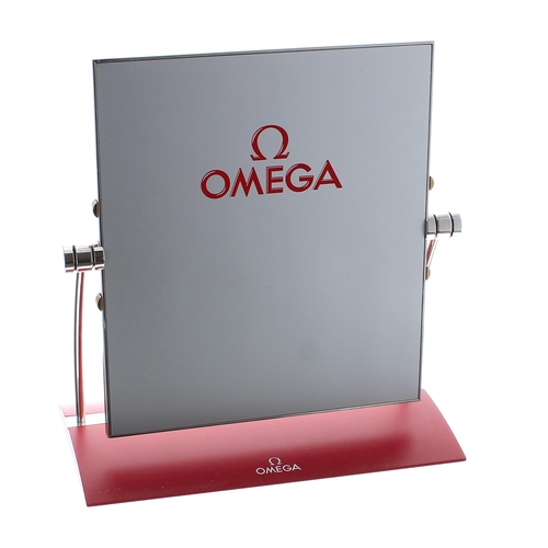 384 - Omega counter display mirror, with signed red base and the mirror signed verso, 10.5'' high, 10'' wi... 