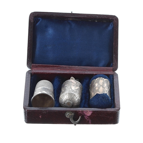 825 - Cased antique silver tape measure, pin cushion and thimble, the case 60mm wide