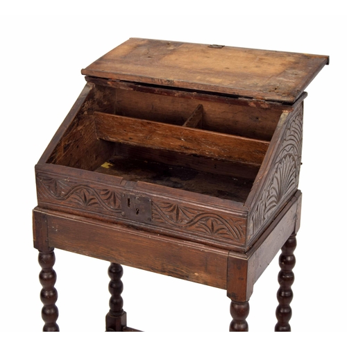 1328 - 17th century and later oak table writing box, with sloped hinged cover enclosing an open interior wi... 