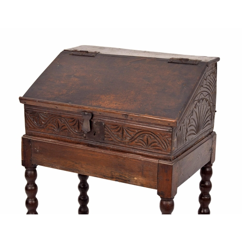 1328 - 17th century and later oak table writing box, with sloped hinged cover enclosing an open interior wi... 