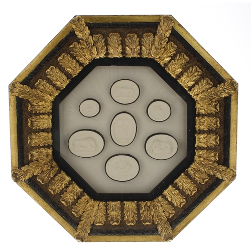 92 - Three glazed octagonal frames containing a selection of plaster intaglio casts and seals after the A... 