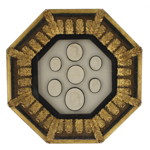 92 - Three glazed octagonal frames containing a selection of plaster intaglio casts and seals after the A... 