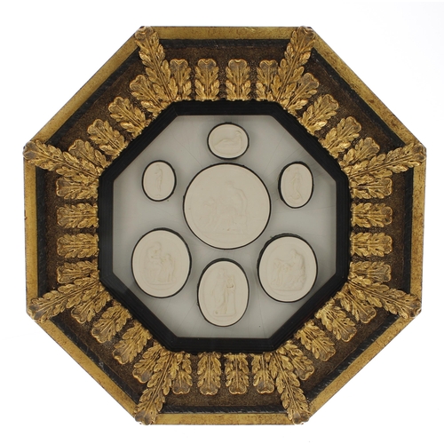 92 - Three glazed octagonal frames containing a selection of plaster intaglio casts and seals after the A... 