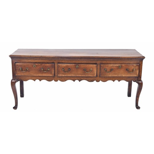 556 - George III oak dresser base, the moulded top over three walnut cross banded drawers with applied bra... 