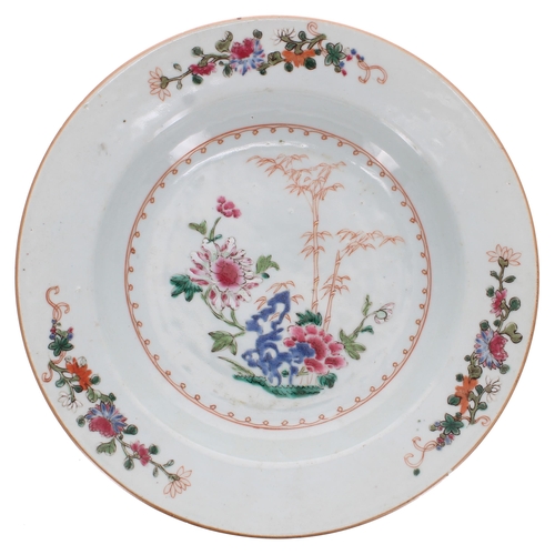 232 - Two Chinese famille rose porcelain plates and a shallow bowl, each decorated with flowers, Qianlong,... 