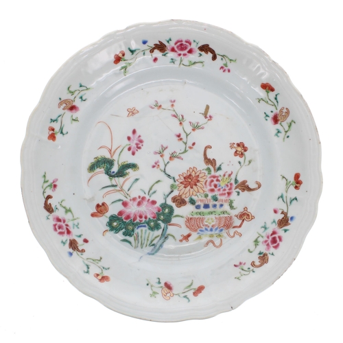 232 - Two Chinese famille rose porcelain plates and a shallow bowl, each decorated with flowers, Qianlong,... 