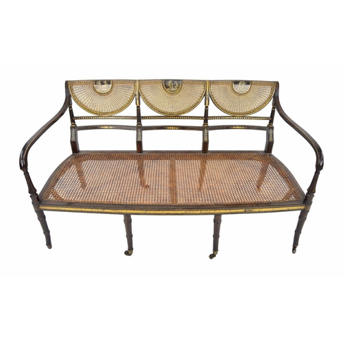 554 - Regency painted simulated rosewood and parcel gilt salon settee, the triple scallop bergére back pai... 