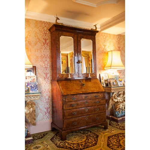 566 - Fine George II feather banded walnut bureau cabinet, the moulded cornice over a pair of glazed mirro... 