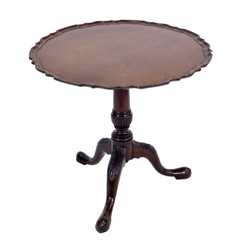 557 - George III mahogany circular tripod table, the tilt-top with a piecrust border upon a turned and ree... 