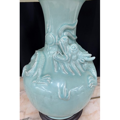 306 - Chinese celadon glaze porcelain table lamp, decorated in relief with a dragon, with shade, the lamp ... 