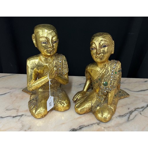 337 - Pair of Thai parcel-gilt carved wooden figures modelled in prayer, 10.5