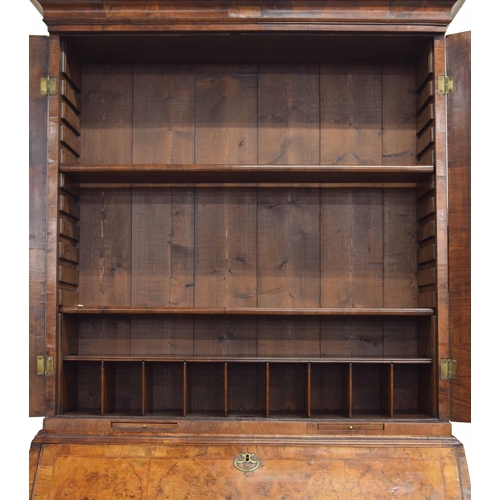 566 - Fine George II feather banded walnut bureau cabinet, the moulded cornice over a pair of glazed mirro... 