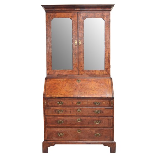 566 - Fine George II feather banded walnut bureau cabinet, the moulded cornice over a pair of glazed mirro... 