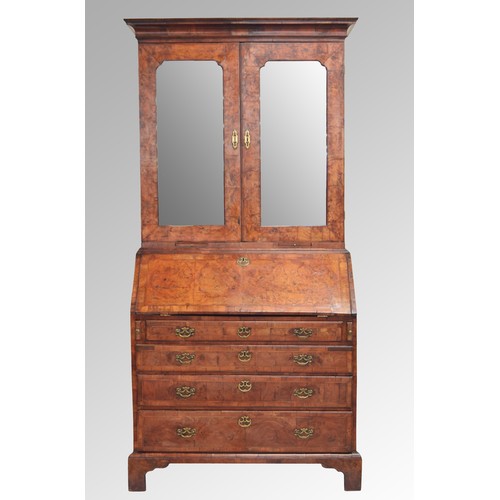 566 - Fine George II feather banded walnut bureau cabinet, the moulded cornice over a pair of glazed mirro... 