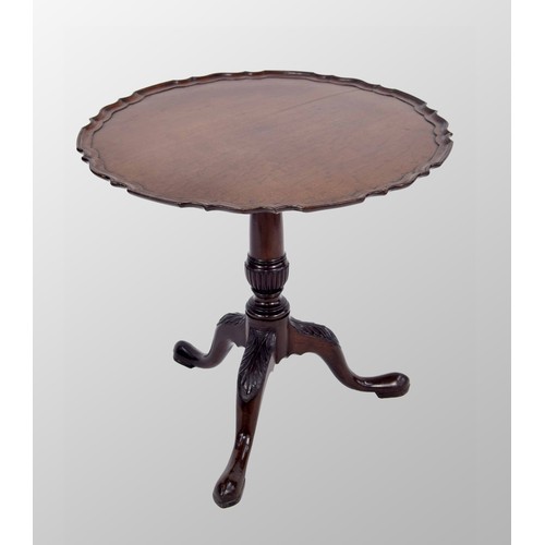 557 - George III mahogany circular tripod table, the tilt-top with a piecrust border upon a turned and ree... 