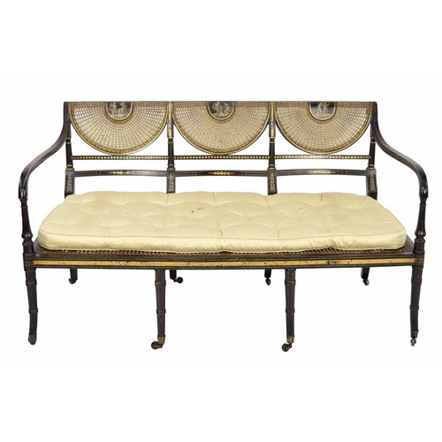 554 - Regency painted simulated rosewood and parcel gilt salon settee, the triple scallop bergére back pai... 