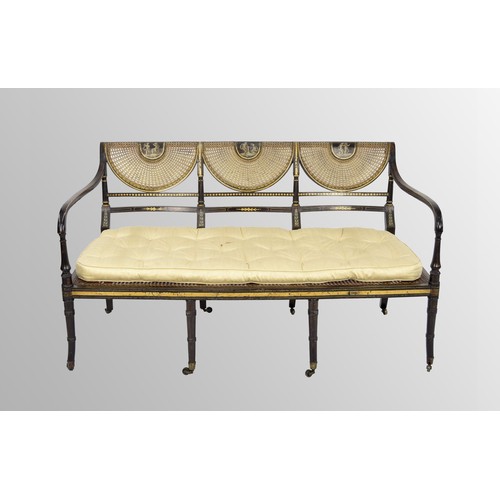 554 - Regency painted simulated rosewood and parcel gilt salon settee, the triple scallop bergére back pai... 