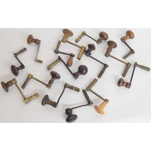 2101 - Fifteen brass and iron crank keys with turned wooden handles (15)