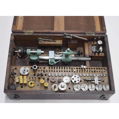 2113 - Small watchmakers lathe, within a fitted wooden case with various collets and other attachments (inc... 