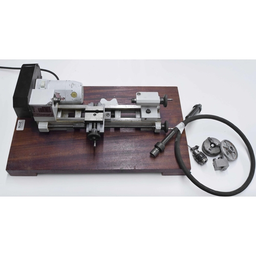 2116 - Unimat Emico electric lathe with attachments, fitted onto a mahogany plinth, 20