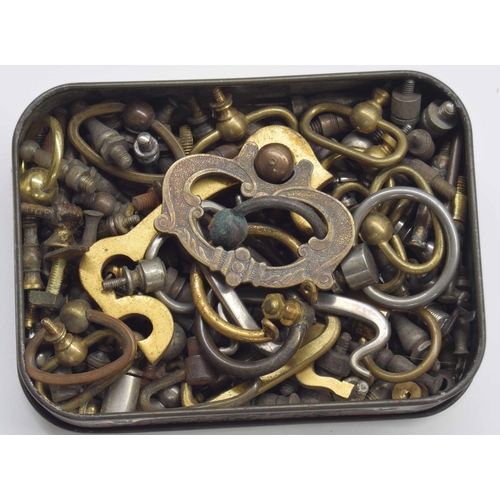 2119 - Small tin containing assorted clock handles and feet