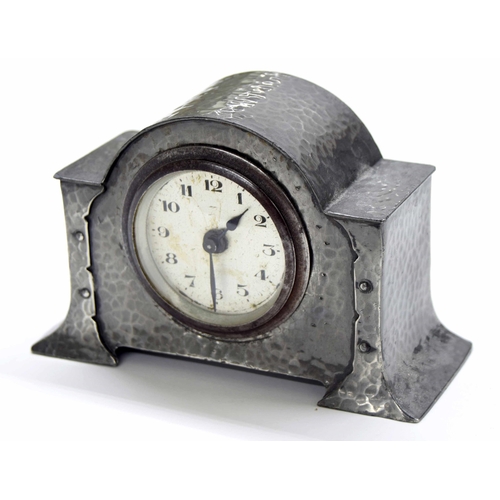 2508 - English Arts & Crafts style small planished pewter mantel clock timepiece, within a rounded arch... 