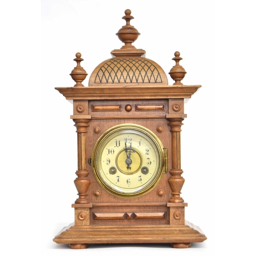 2309 - Junghans walnut two train mantel clock striking on a gong, within an architectural pillared case sur... 