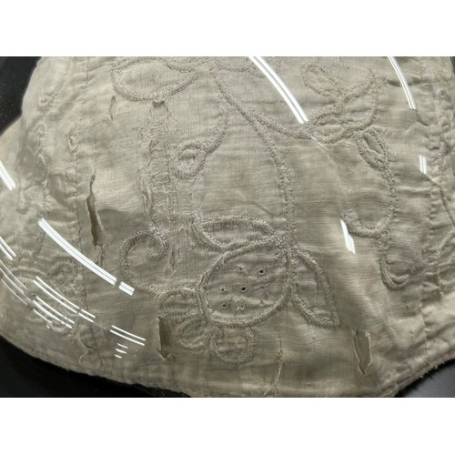 103 - Interesting embroidered night cap displayed beneath a dome, possibly 17th century, the dome 10