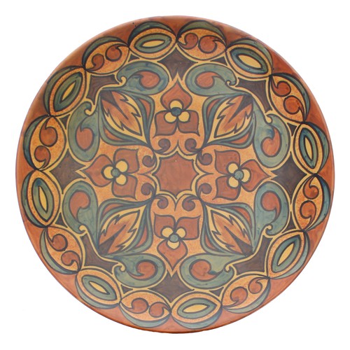 816 - Clews & Co. Chameleon Ware hand painted charger with stylised foliate decoration on a natural gr... 